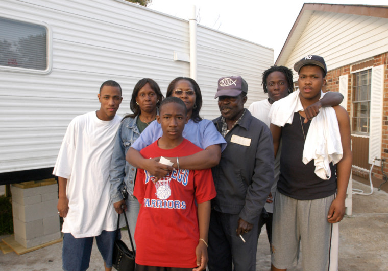 Maxine Harris and her family pose outside their home in Westwego, La. From left, nephew Carlos Page, sister Vivian Page, grandson Charles Harris, Maxine Harris, husband John Harris, and nephews Solomon and Corey Page.