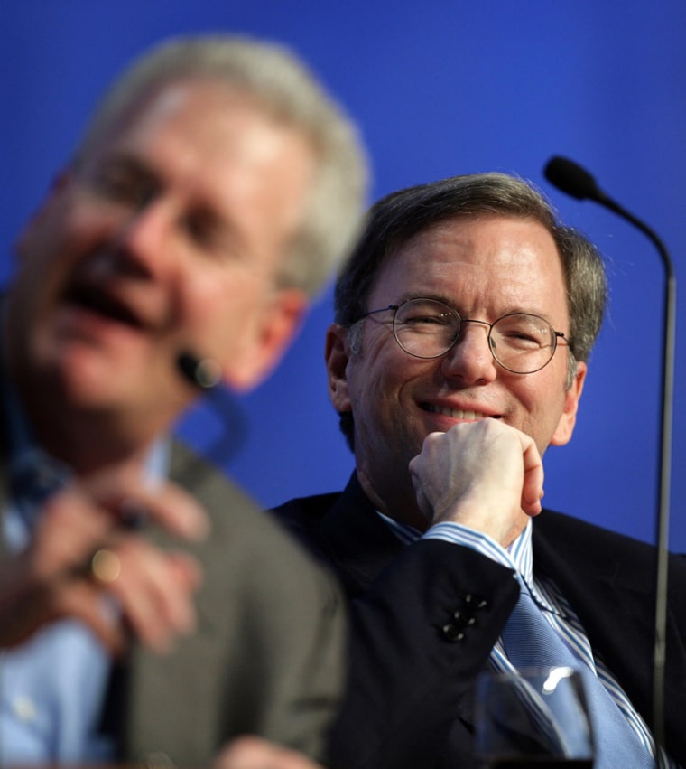 Moore, Managing Director at TCG Advisors, and Google CEO Schmidt laugh during a session at the World Economic Forum in Davos