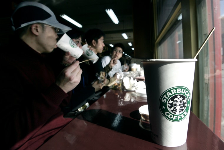 Chinese customers drink coffee at a Starbucks outlet in Beijing