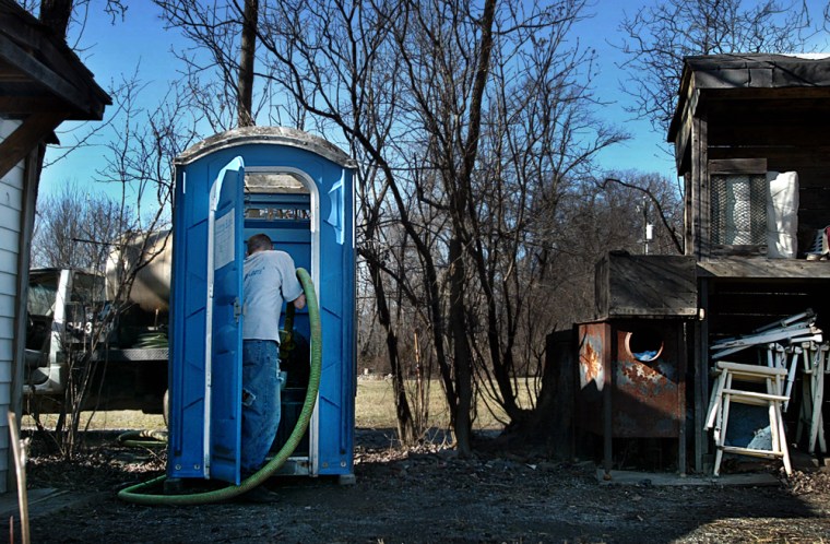 Kenny Waybright, 34, of Johnny Blue, Inc., cleans the outhouse of Ann B. Lee, a resident of Willisville, a tiny African-American community surrounded by the affluent horse country of western Loudoun County, Va. Most of Willisville has no indoor plumbing.