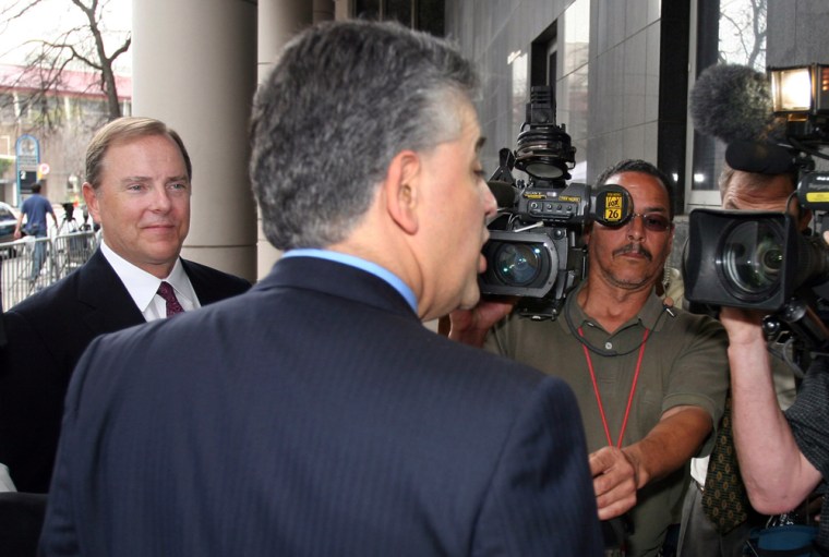 Former Enron CEO Skilling listens as his attorney Petrocelli talks to reporters outside Federal Building in Houston