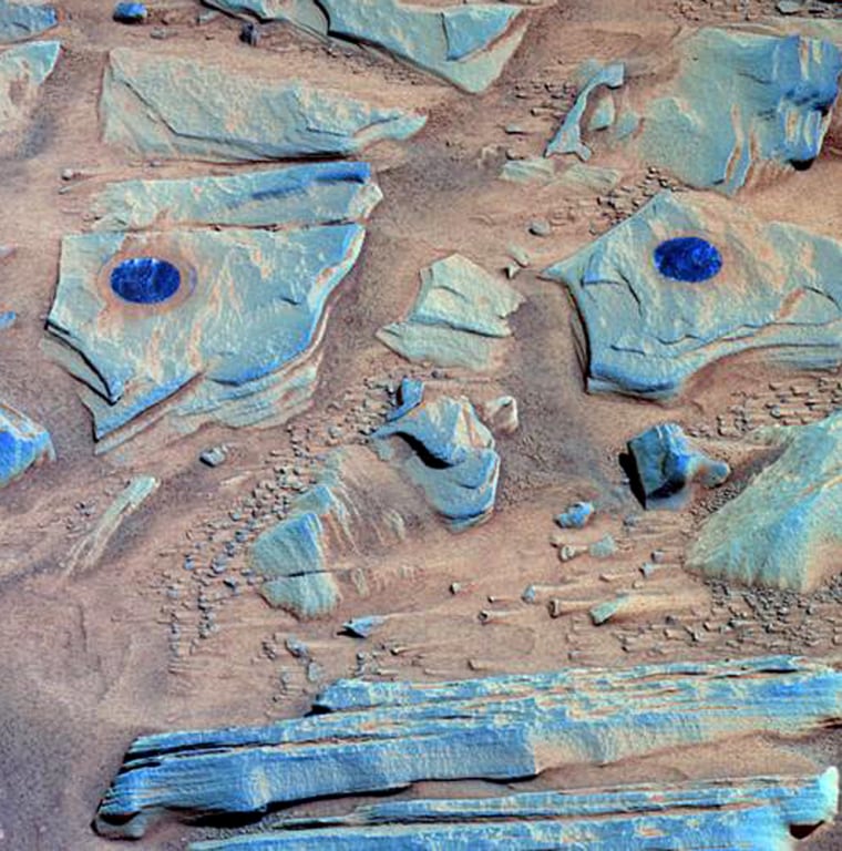 NASA's Spirit rover snapped this picture on Feb. 26 after using its rock abrasion tool to brush the surfaces of rock targets informally named "Stars" (left) and "Crawfords" (right). The brush marks look blue in the false-color image.