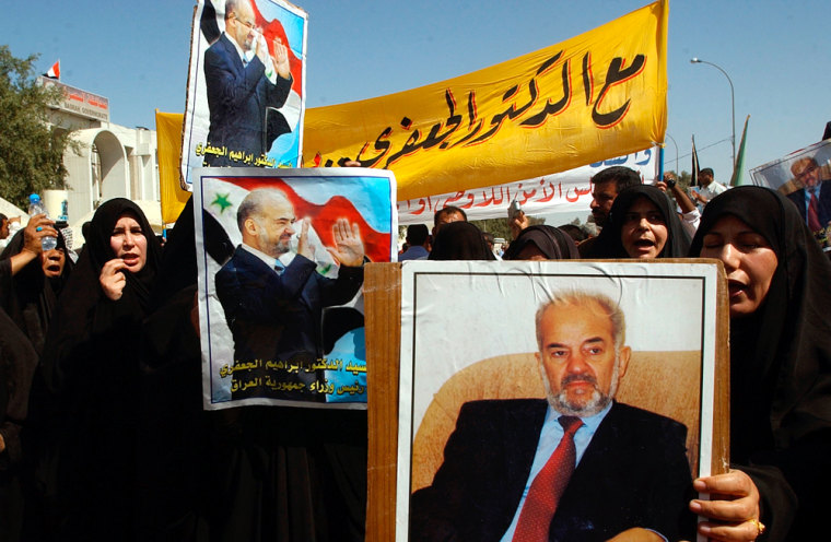 Iraqi women carry posters of Prime Minister Ibrahim Al-Jaafari during a demonstration Tuesday in Basra.