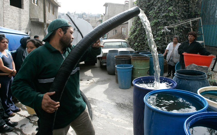 A city worker delivers the weekly ration of water into plastic drums for residents of a low income neighborhood in Mexico City, Mexico on Thursday March 9, 2006. According to a recently released report by the U.N., 15 percent of of the 540 million people living in latin America and the Caribbean do not have access to safe drinking water. (AP Photo/Dario Lopez-Mills)