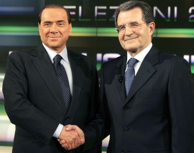 Italy's Prime Minister Silvio Berlusconi, left, and his center-left coalition election opponent Romano Prodi shake hands prior to the start of their face-to-face prime-time debate on state-run broadcaster RAI , in Rome, Tuesday, March 14, 2006. The prime-time debate on RAI has represented the highlight so far in the campaign before the April 9-10 election, and was expected to draw millions of viewers. (AP Photo/Pier Paolo  Cito)