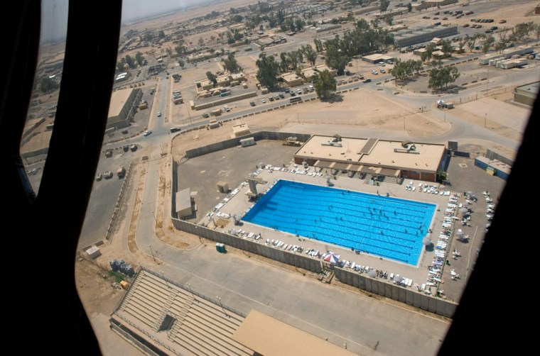 ** ADVANCE FOR TUESDAY MARCH 21 ** The swimming pool at Balad air base as seen through the window of a blackhawk helicopter,70 kilometers (44 miles) north of Baghdad, Iraq, Aug. 25, 2005. As the construction work goes on in full scale in Balad U.S. air base and handful of other installations, with Burger King and Pizza Hut already in, It is difficult to say weather U.S. forces in Iraq are here to stay for a short term or a long term. Nonetheless, if long term basing is on the horizon, there is no one to confer such plans. (AP Photo/Jacob Silberberg)