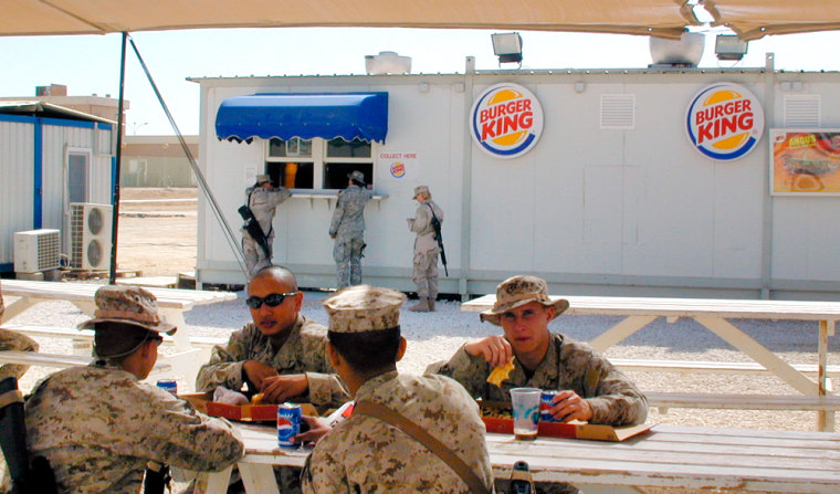 U.S. soldiers eat meals from Burger King, in al-Asad air base west of Baghdad. Elaborate bases like this one raise questions about how long the U.S. intends to stay in Iraq.  (AP Photo /Charles J. Hanley)
