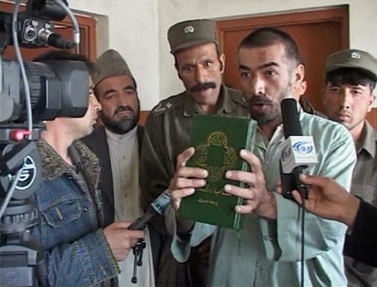 Frame grab shows Rahman holding a translated version of Bible in Kabul court