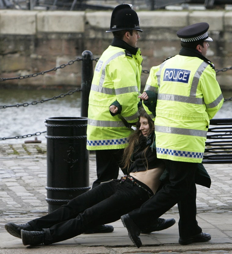 Police remove a protester before U.S. Secratary of State Condoleezza Rice's and British Foreign Secretary Jack Straw's visit to the Merseyside Maritime Museum in Liverpool, England, on Saturday.