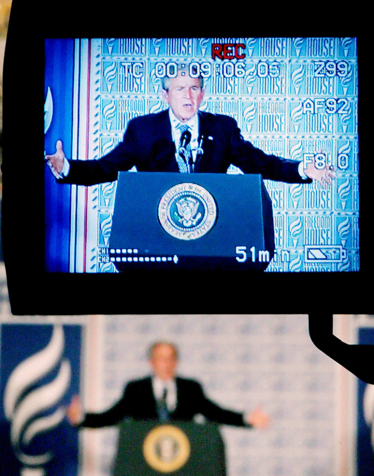 US President Bush is seen on monitor as he remarks to Freedom House in Washington