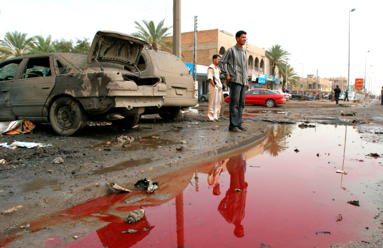 An Iraqi man looks out over a bloody puddle at the site of a car bomb Monday April 3, 2006 in Baghdad, Iraq.  Two car bombs exploded in Baghdad on Monday, killing a bystander and wounding half a dozen others as U.S. Secretary of State Condoleezza Rice and British Foreign Secretary Jack Straw urged Iraqi leaders to form a government as soon as possible to curb the bloodshed and rein in sectarian militias behind much of the country's violence.(AP Photo/Karim Kadim)