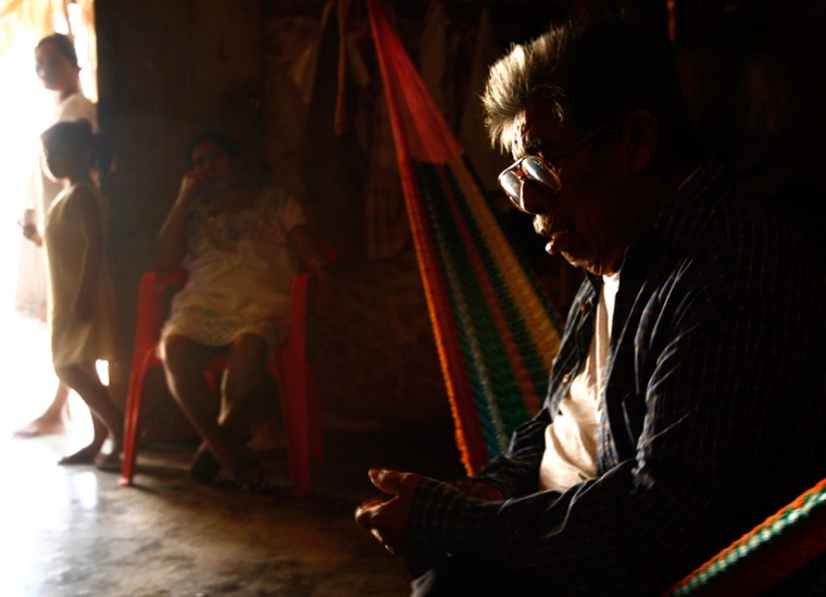 Luis Xool, 78, sits on a hammock at his home while relatives stand near the door in the town of Pino Suarez, in Mexico Yucatan peninsula on April 1. Xool, who is almost completely blind, will travel to Venezuela to undergo eye operations, courtesy of Hugo Chavez's government.