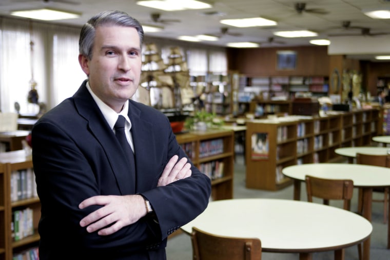 Brother Kenneth M. Hoagland, principal of Kellenberg High School, stands in the school's library in Uniondale, N.Y., in October. Hoagland sparked a national debate when he canceled the senior prom.