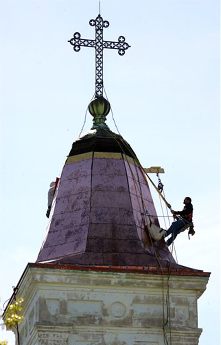 Repair work continues on the the bell tower of St. Augustine, a 19th-century Roman Catholic church in New Orleans in this March 15 photo. One of the nation's oldest black Catholic parishes, the church recently lost its priest and was merged with another congregation. 