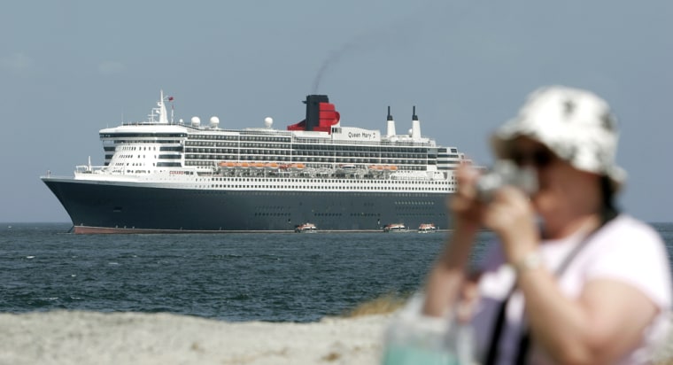 A tourist takes a photo with Queen Mary 2, the world's biggest cruise ship, in the Panama bay in Panama City, Panama, Wednesday, Feb. 15, 2006.