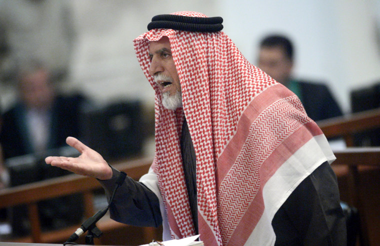 Awad al-Bandar, a former judge, testifies Thursday during his trial in Baghdad.