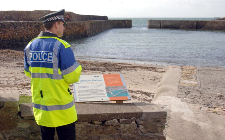 A policeman looks out over the harbour of Cellardyke on the east coast of Scotland 450 miles north of London on April 6. 