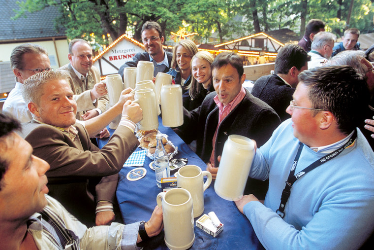 Visitors clink mugs at the annual festival called Bergkirchweih in Erlangen, southern Germany, in May 2005.