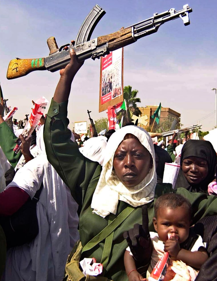 A woman holds an assault rifle during an anti-U.N. peacekeeper demonstration in Khartoum, Sudan, on March 8.