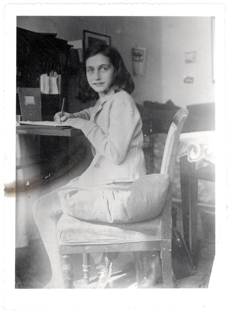Anne Frank writes at a desk in this April 1941 image released by the Anne Frank Foundation on Tuesday.