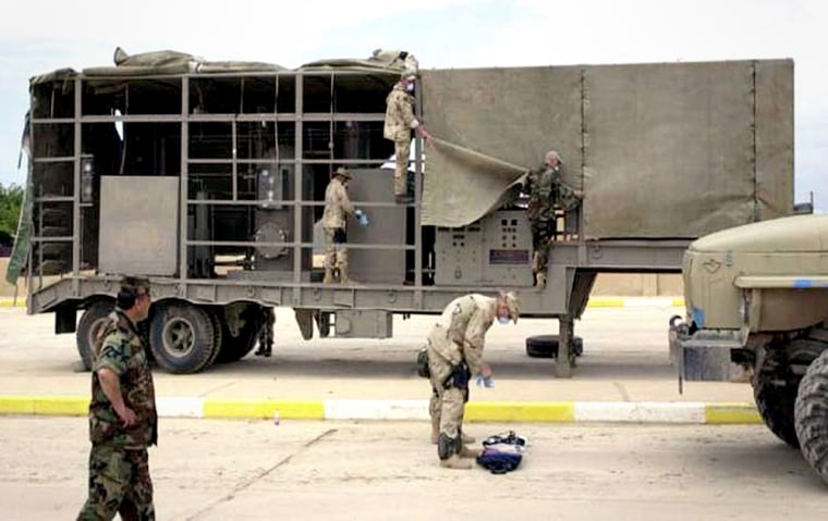 U.S. military personnel examine a suspected mobile biological weapons facility recovered in northern Iraq in April, 2003. The White House announced the trailers were evidence that Saddam Hussein had prohibited weapons systems, but a team of experts dispatched by the Pentagon came to the opposite conclusion. 