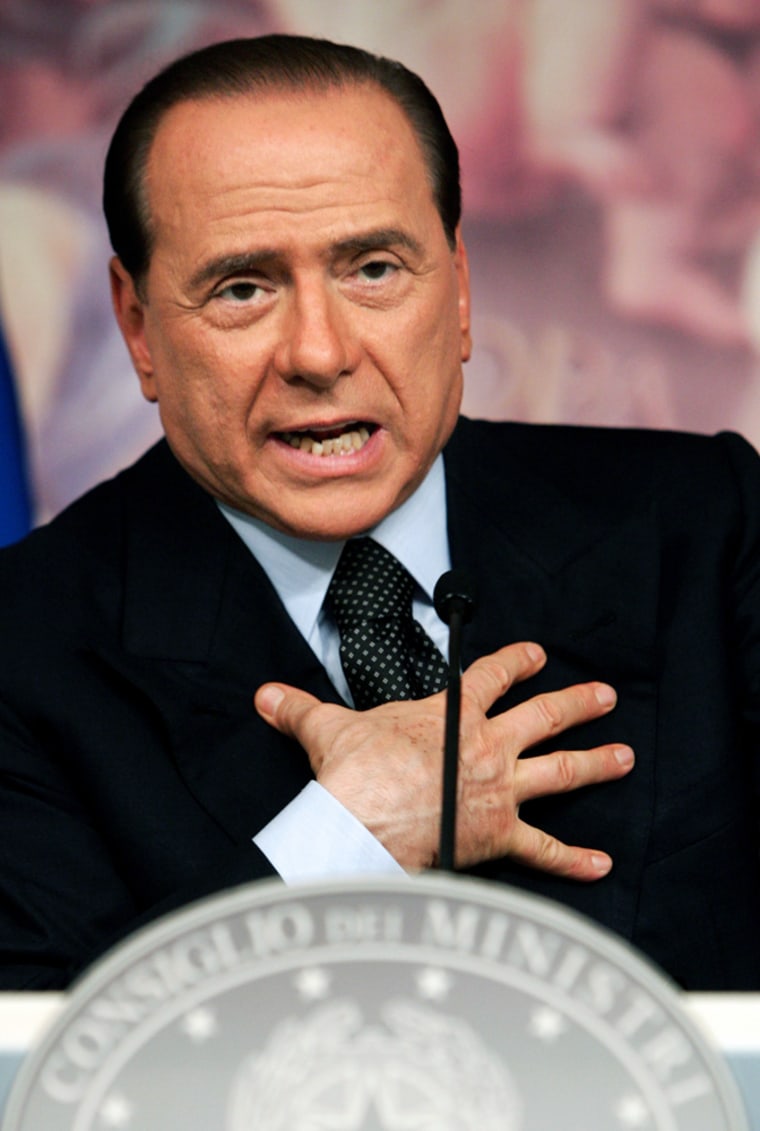 Italian PM Berlusconi gestures during news conference in Rome