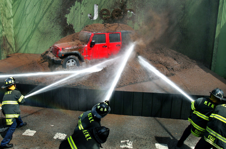 New York City firemen spray mud off all-new 2007 Jeep Wrangler Unlimited at New York International Automobile Show in New York