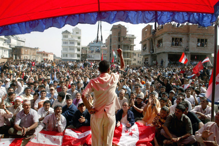 Opposition party supporters listen Thursday to a leader at a meeting in Katmandu, Nepal. The government has banned rallies in Katmandu and surrounding areas.