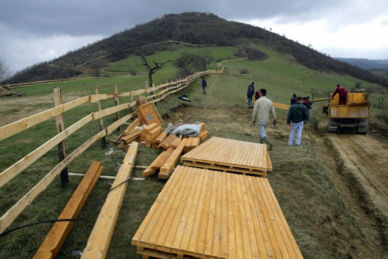 Workers prepare to construct temporary office near Visocica hill in central Bosnia