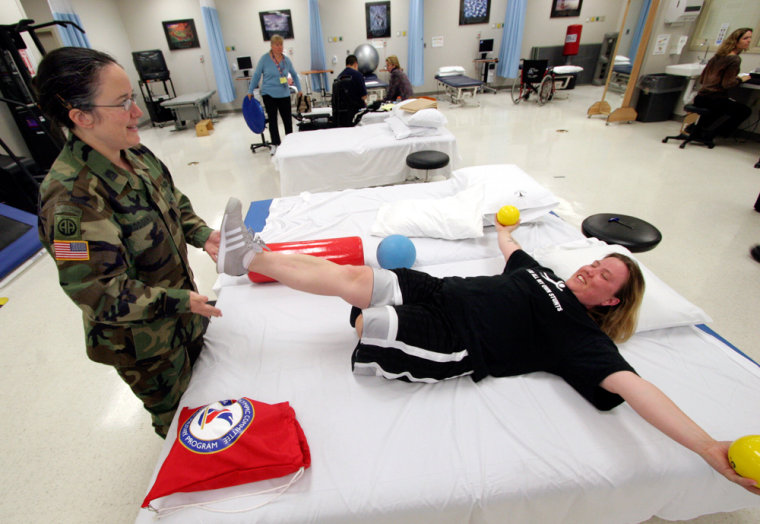Sgt. Carla Best, who lost her leg in Iraq, works with her physical therapist, Capt. Marilyn Rodgers, in the  at Walter Reed Hospital.
