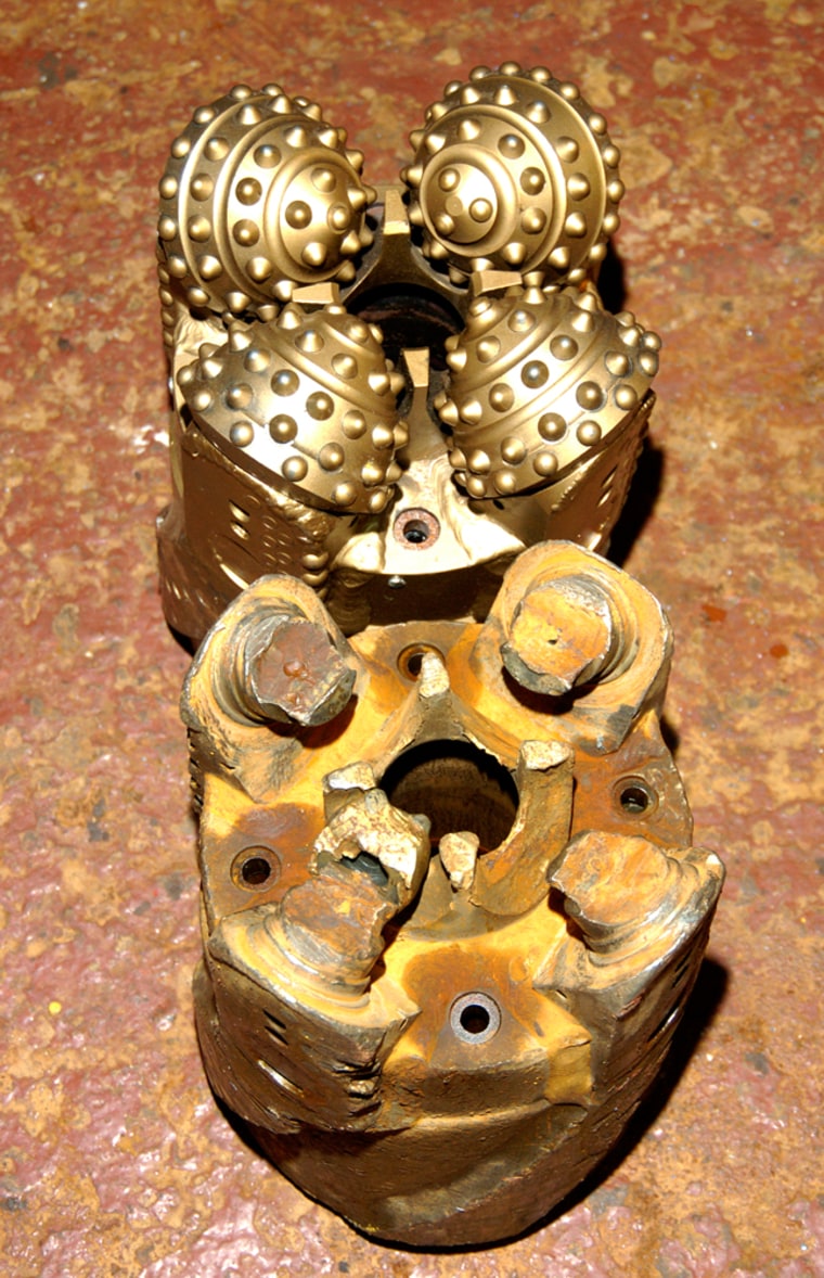 New (top) and badly damaged (bottom) rock-coring drill bits used to penetrate to the oceanic gabbro layer at Integrated Ocean Drilling Program Site 1256. Bit diameter 25 cm.