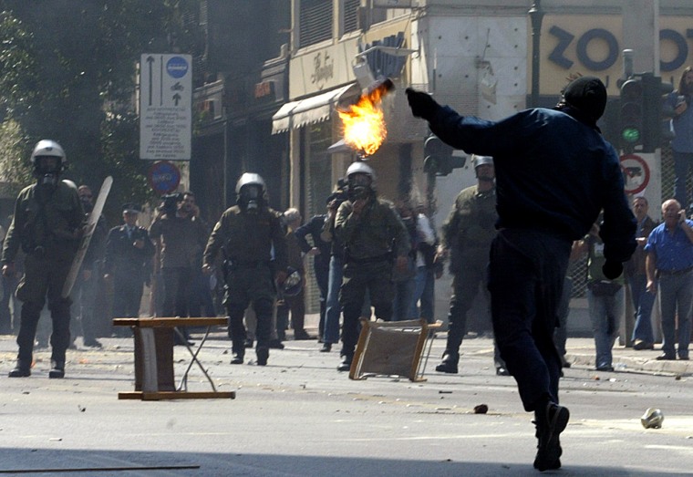 Protestors clash with riot police during