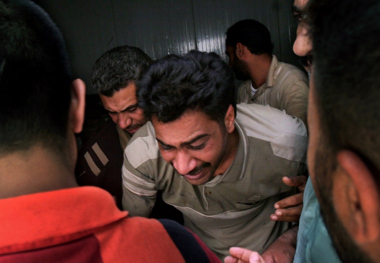 Grieving relatives leave a morgue Wednesday after identifying the body of a man killed by a roadside bomb explosion in Baghdad, Iraq. 