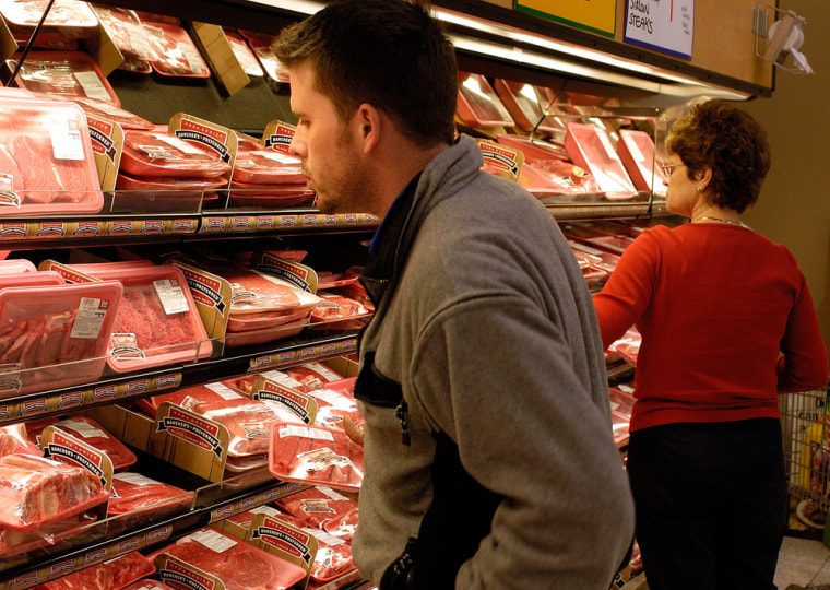 Dan Hogan, left, looks for a good cut of meat  at the Cub Foods grocery store in Burnsville, Minn.