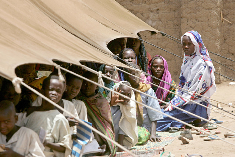 Sudanese refugee children sit in their makeshift classroom April 19 in the refugee camp Kou Kou Angarana in Chad near the Sudan border.