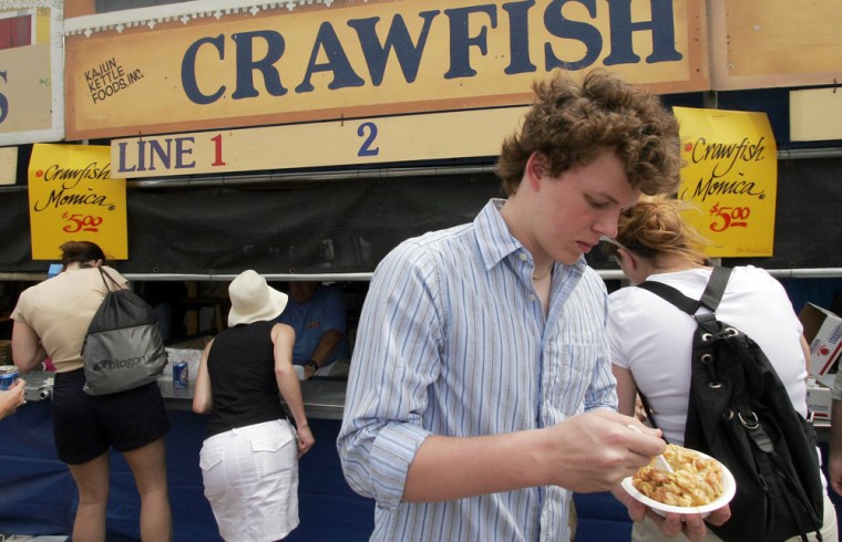 Cordt Akers of Houston digs into a crawfish dish during the New Orleans Jazz and Heritage Festival in New Orleans on Saturday.