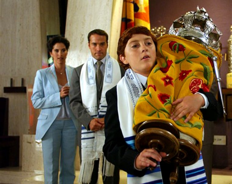 In this photo provided by Miramax Films, Benjamin Fiedler (Daryl Sabara, front) must cope with his parents (Jami Gertz and Jeremy Piven, back) but with the pressures of his Bar Mitzvah in 'Keeping Up With the Steins.' (AP Photo/Miramax Pictures)