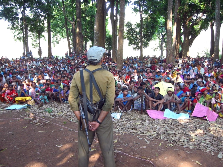Comrade Kosa, a senior Naxalite commander, addresses roughly 2000 tribal militia and supporters at a rally in Bastar forest recently. Kosa agreed to be photographed only on condition that his face not be shown. 