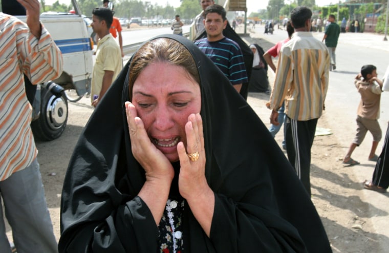An Iraqi woman reacts at the scene of a roadside bomb attack that missed a police patrol, but hit a civilian bus in Baghdad, Sunday, May 14, 2006. Five roadside bombs and two suicide car bombs exploded one after another in Baghdad on Sunday morning, killing a total of 12 Iraqis and wounding 37, police said. (AP Photo/Karim Kadim)