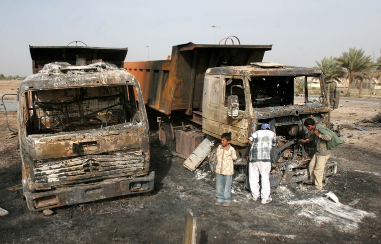 Iraqi children inspect wreckages of vehicles burnt following a car bomb attack Baghdad, Sunday, May 14, 2006. Two suicide car bombs that exploded near a main checkpoint on a four-lane road leading to Baghdad's international airport, killing at least 14 Iraqis and wounding six.(AP Photo/Hadi Mizban)