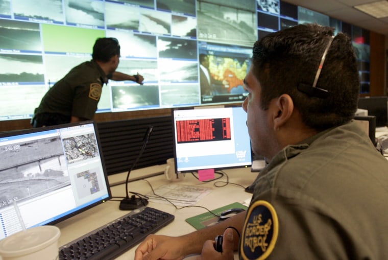 U.S. Border Patrol agents watch surveillance video in Laredo Texas