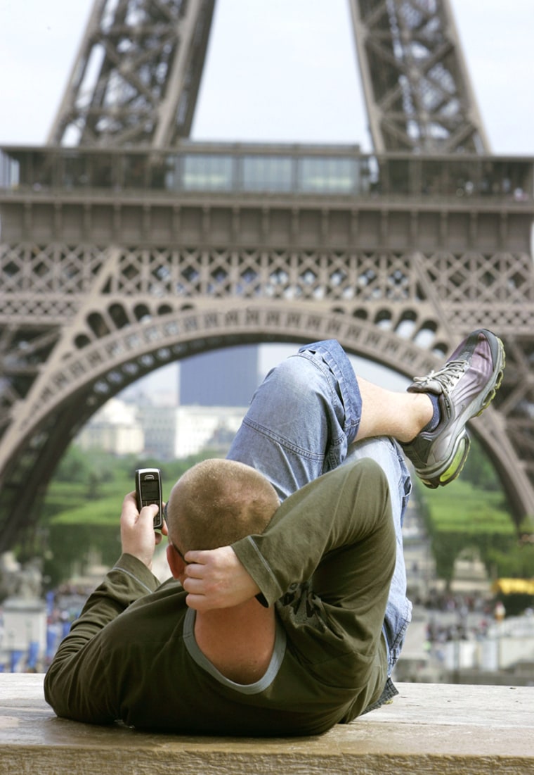 An unidientified man uses a cellular phone next to the Eiffel Tower in Paris, Monday, May 15, 2006. Europeans are no strangers to eavesdropping: East Germans lived for decades with the all-pervasive Stasi secret police, the French had a president with a penchant for wiretaps, while the British had \"Camillagate\", when Prince Charles was taped making a steamy call to the woman who is now his wife.. (AP Photo/Michel Euler)