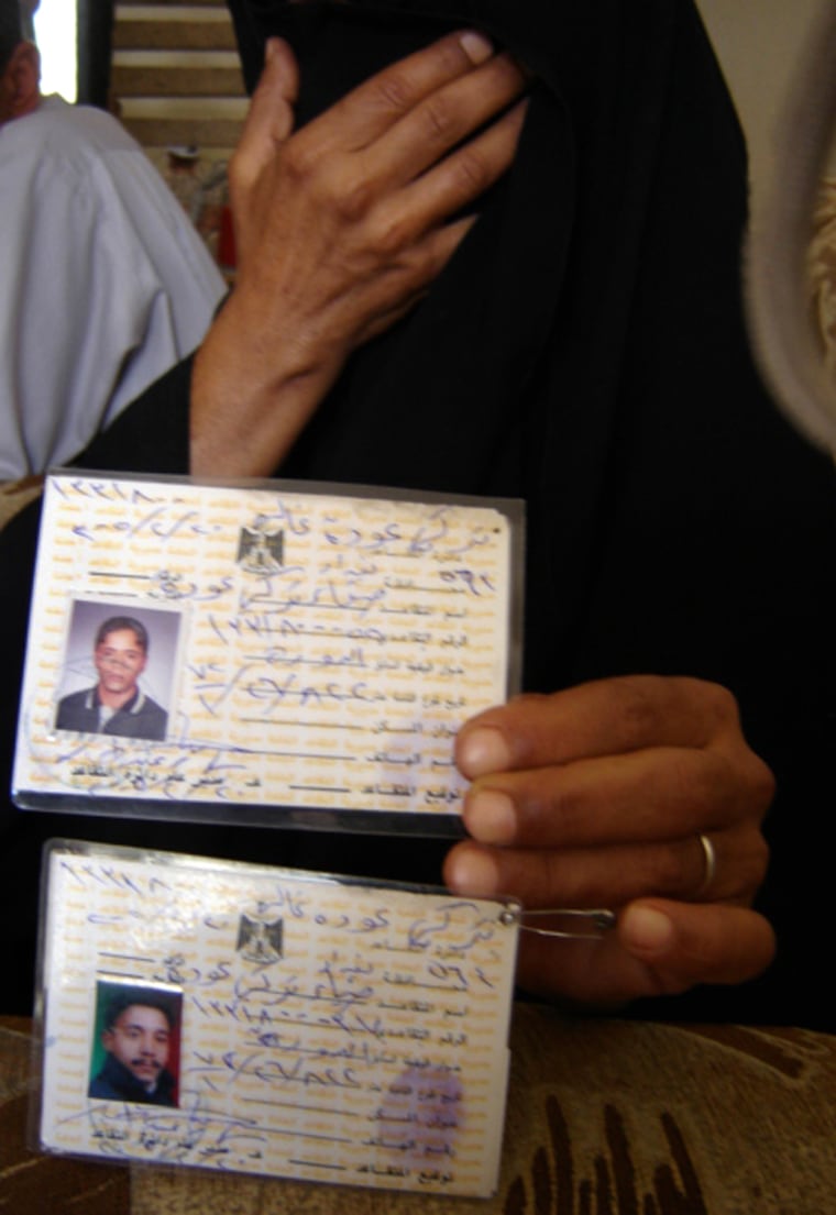 Hiding her face, Fahdriya Obeid, 50, a Sunni Arab, holds government-issued cards showing her missing sons. After the widow’s search took her to Baghdad's Shiite slum of Sadr City, a man identifying himself as an Interior Ministry official relayed a message through a Sunni relative: “We don't want to ever see you at Sadr City. Or the morgue.”