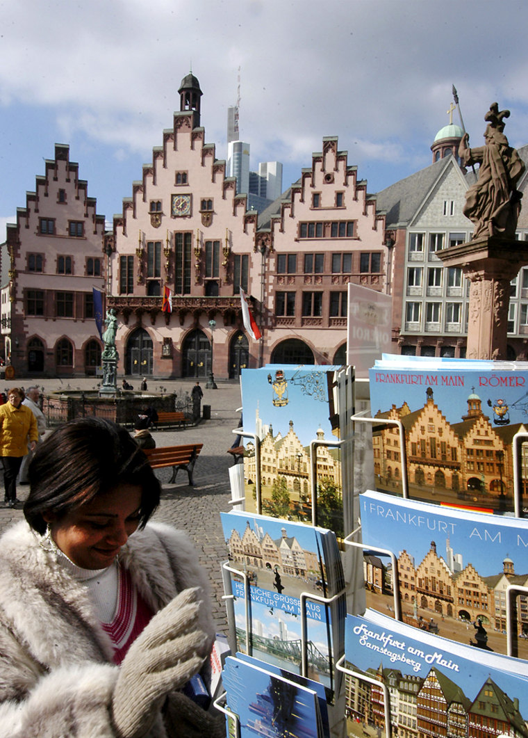** FILE ** A tourist looks for postcards in front of the Frankfurt city hall, known as Roemer, in Frankfurt, Germany, in this March 10, 2005 file picture. Frankfurt is one of the host cities of the soccer World Cup 2006. (AP Photo/Bernd  Kammerer)