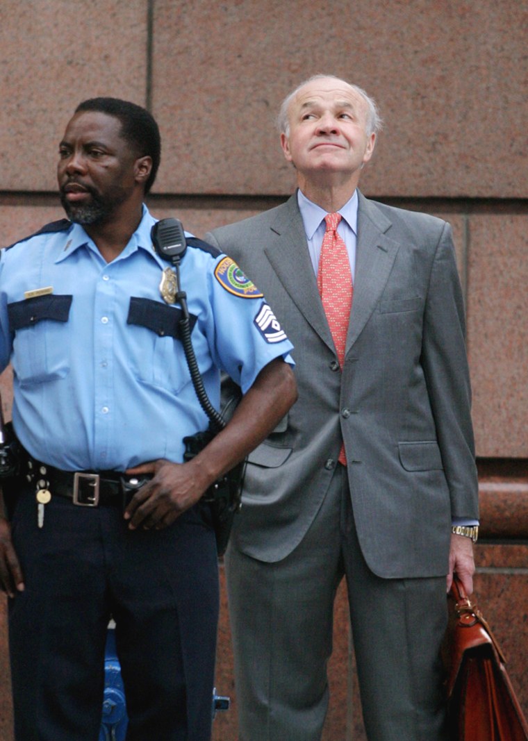 File photo of former Enron chairman Lay looking up at overcast skies as he arrives at Federal court in Houston
