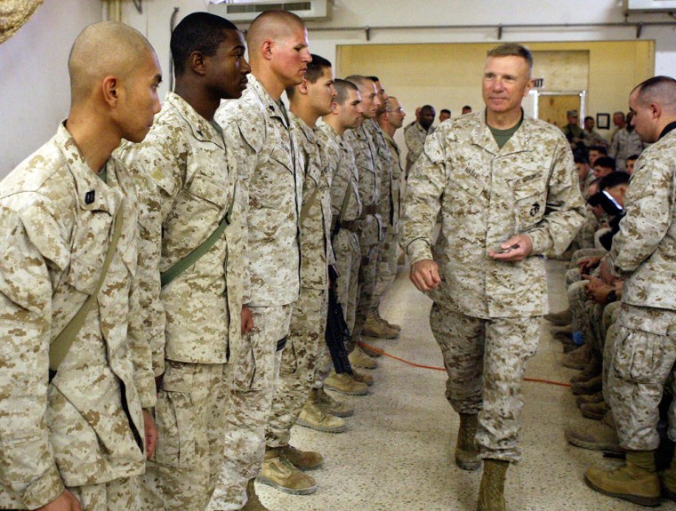 Commandant of the Marine Corps Gen Hagee walks down the ranks of Marines and sailors at Al Qa'im