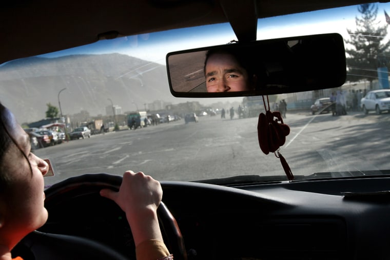 Sofia Ziaee, 14, drives her father’s car in downtown Kabul, Afghanistan, on May 13.