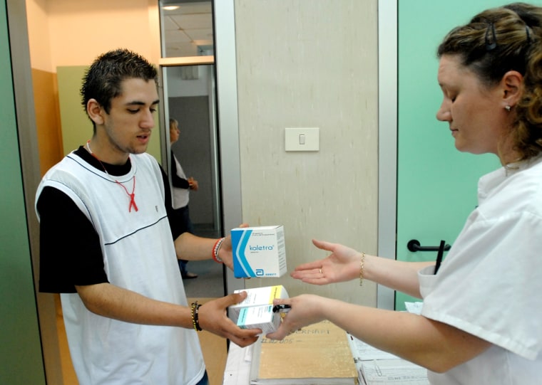 Adrian Calea, 18, left, an HIV-positive Romanian receives his daily medication from a nurse at a Bucharest hospital. He is one of more than 7,000 Romanian children who were infected between 1987 and 1990 because the communist regime made it a practice to re-use syringes and give transfusions of untested blood. 