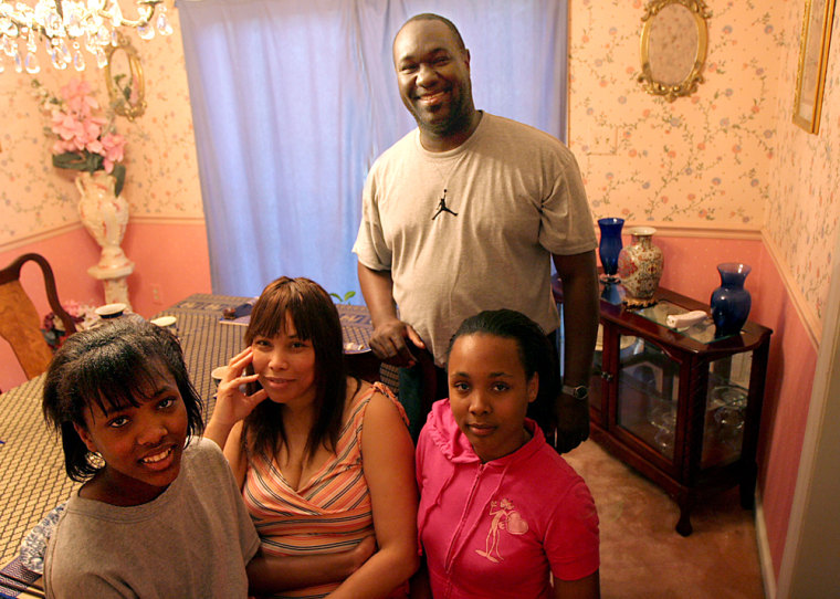 Beverly, center, and Kevin Queen, right, with two of their five children Donna, 14, left, and Angela, 13, right, are seen at the family's Fort Washington, Md., home, which they bought using $2,500 they received through the AmeriDream down payment program.