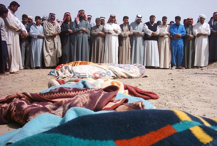 Iraqis pray during the funeral of victims after a U.S. raid in the village of Ishaqi